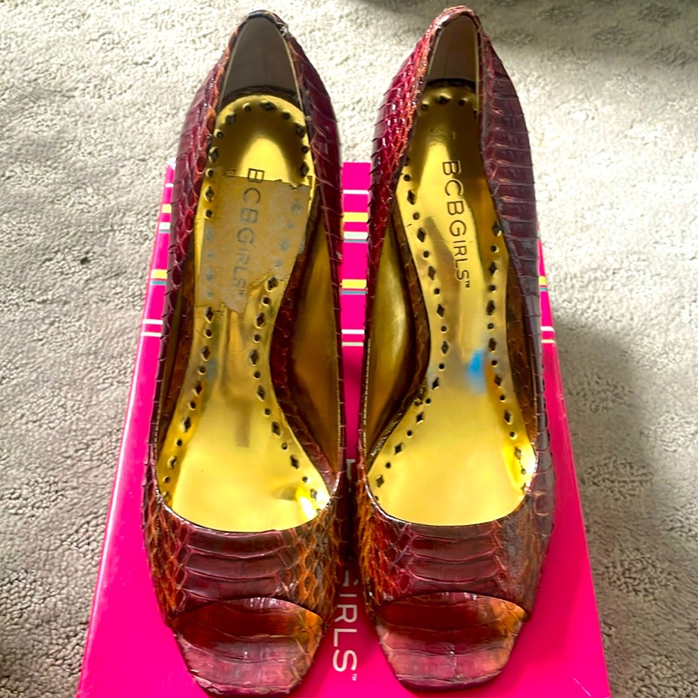 Maroon snake skin open toed heels.